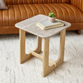 Gus Modern Portico End Table in White Oak with travertine top, styled in a modern living room setting with a leather sofa and textured rug.