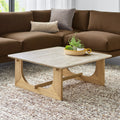 Portico Square Coffee Table by Gus Modern in white oak shown in a modern living room with travertine top and plush brown sectional.