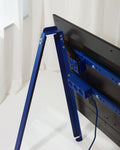 Pedestal Remote Box Mount in Ultra Marine, fitted to the crossbar behind a screen on a blue Pedestal stand