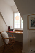 scandinavian work desk with ceiling pendant above oak desk