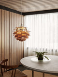 Louis Poulsen PH Artichoke pendant in copper lighting a Scandinavian dining nook with wood panelled walls