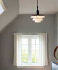 ph 3/3 pendant in a bedroom designed by poul henningsen for louis poulsen