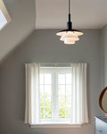 ph 3/3 pendant in a bedroom designed by poul henningsen for louis poulsen