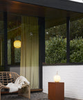 exterior of big window with suspended scandinavian light fixture 