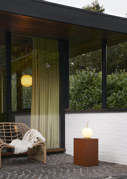 exterior of big window with suspended scandinavian light fixture 