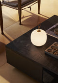 vl45 white opal portable lamp on a coffee table from Louis Poulsen