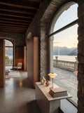Louis Poulsen PH 1/1 Portable lamp in chrome on a marble console in a stone villa overlooking a lake