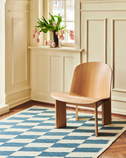 HAY Arcs Vase, Large, Mirror, mirror finish steel vase, holding pink tulips on a windowsill above an oak chair and blue checkerboard rug