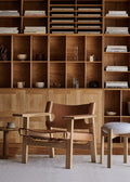 Pioneer Stool by Fredericia with light grey seat next to Borge Mogensen Spanish Chair and oak bookcase