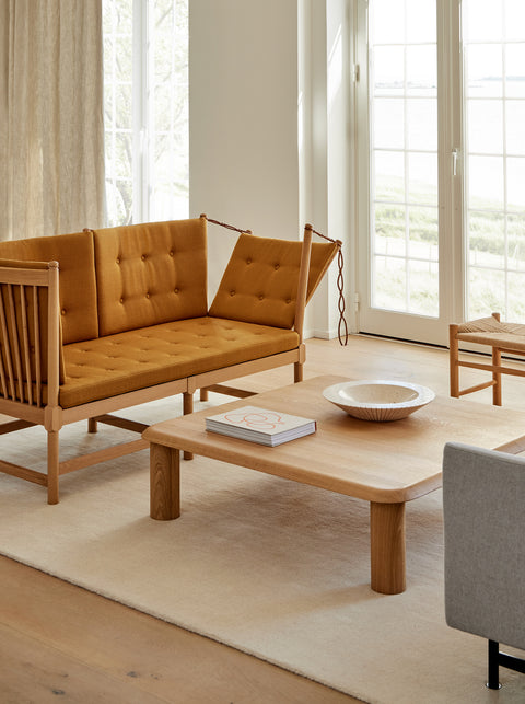 Bright room with mustard Vidar 472 Fredericia Spokeback Sofa styled with an Islet coffee table a J16 stool and a Locus bowl