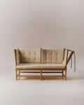 Studio front view of Fredericia Spokeback Sofa in natural linen with oak light oil frame and adjustable ends