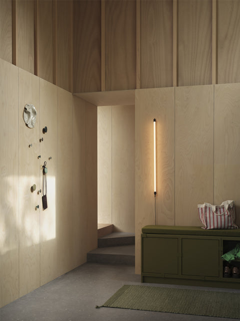 minimalist scandinavian interior with wood panel walls and furniture from Muuto 