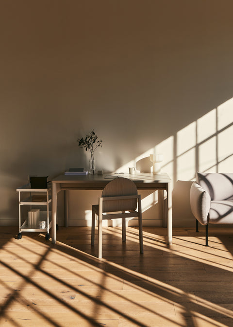 Minimalist workspace with natural wood Cleo Chair by Edits Furniture in sunlight