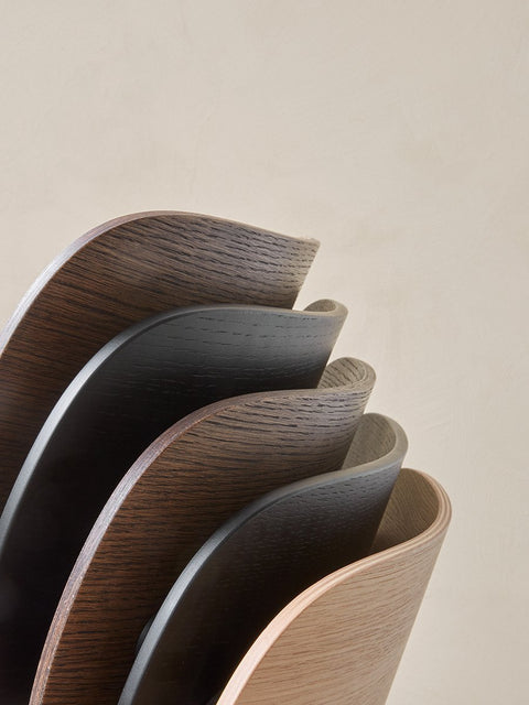 Audo Copenhagen Co Dining Chair, Non-Upholstered, close-up shot of several Co Dining Chair backrests, highlighting the curved form and various wood veneer finishes