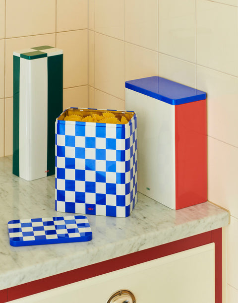HAY Tin Container, Large, Blue and Off-White, lidded tinplate storage tin, open with pasta on a marble counter beside a green and a red tin