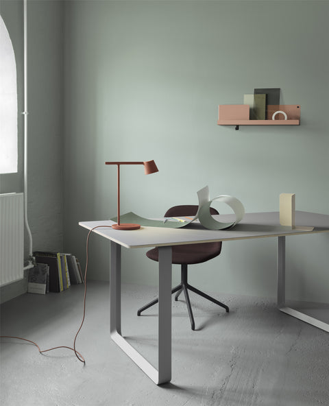 Stylish Muuto folded wall shelves displayed in contemporary home office with clean lines