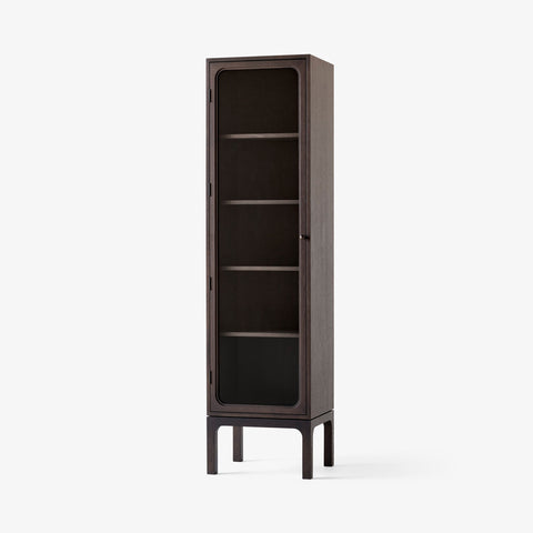 Trace SC87 Cabinet by &Tradition in dark-stained oak with glass door — Scandinavian cabinet design combining warm wood tones and minimalist form.