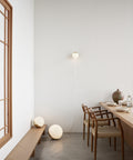 scandinavian dining room with sculptural chairs and ball floor lamp by louis poulsen