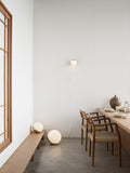 scandinavian dining room with sculptural chairs and ball floor lamp by louis poulsen