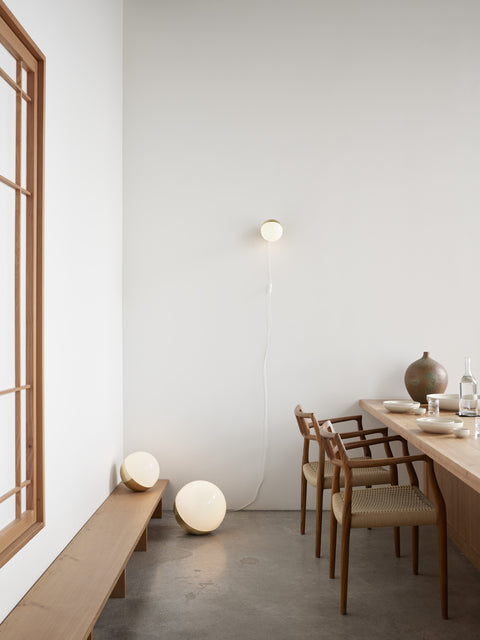 scandinavian dining room with sculptural chairs and ball floor lamp by louis poulsen