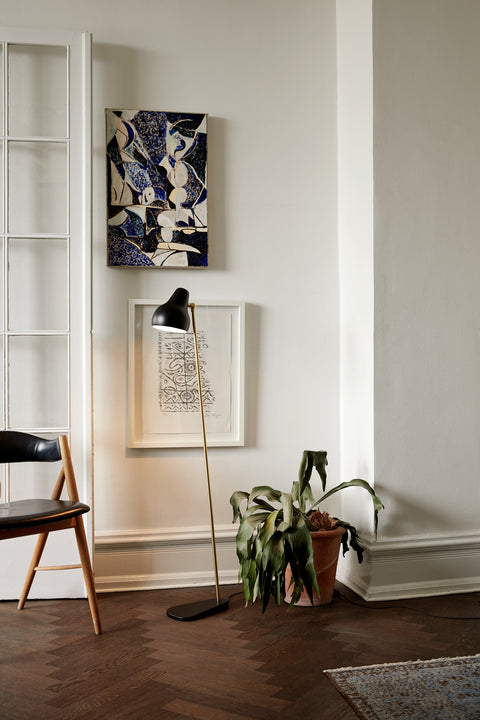 black vl38 floor lamp designed by vilhelm lauritzen in a scandinavian home for louis poulsen