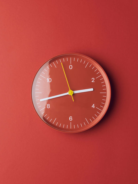 HAY Wall Clock, Red, recycled ABS wall clock, red dial and white hands, mounted flat against a deep terracotta red wall