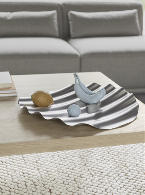 Sleek and functional Muuto Wave Tray on wooden coffee table with designer accessories