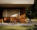 Frama Tasca Stool in Aluminum, two stools pulled up to a long wooden table on the covered terrace of a concrete house