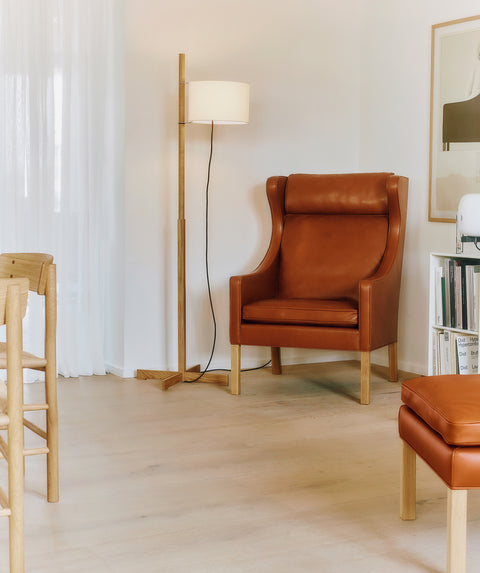 Cognac leather Mogensen Wing Chair in corner with floor lamp and bookcase, oak legs, modern Danish lounge seating, Habitus Canada