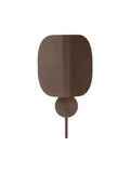 Audo Copenhagen Wing Wall Lamp in bronzed aluminium, curved shade flat against a round wall mount
