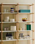 HAY Tin Container, X-Large, Off-White, Burgundy and Green, lidded tinplate storage tin, on pale wood shelving with plates, crates and a jug