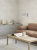 Muuto Ambit Wall Lamp in contemporary living room with soft, warm lighting