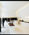 aj eklipta wall lamp in a clothing store designed by louis poulsen