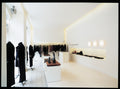 aj eklipta wall lamp in a clothing store designed by louis poulsen