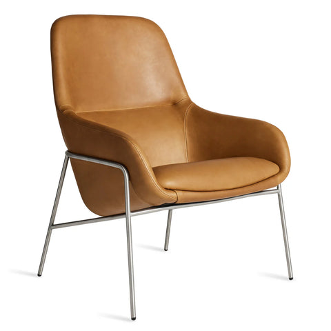 Blu Dot Acre Lounge Chair in tan leather with brushed steel legs, three-quarter front view on white background