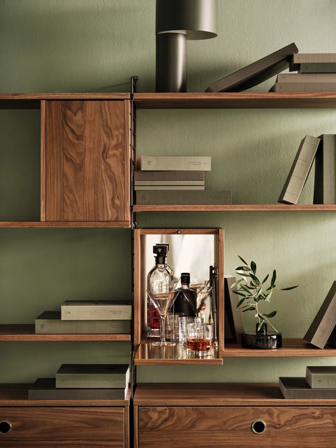 String® System Tiny Cabinet in walnut with mirrored interior, Scandinavian shelving styled as home bar
