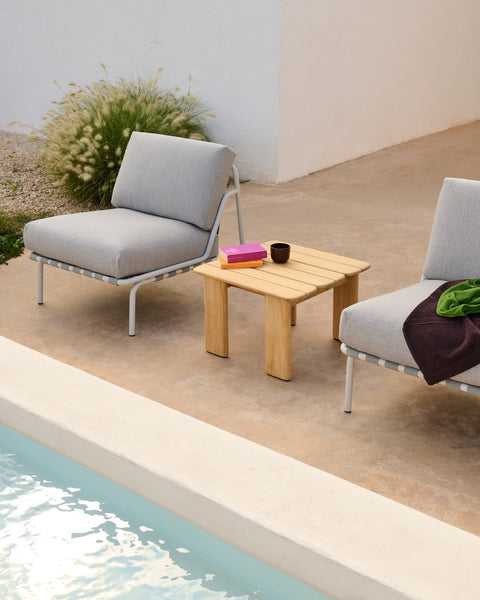 Muuto Settle lounge chairs in grey with Assemble coffee table in teak by poolside