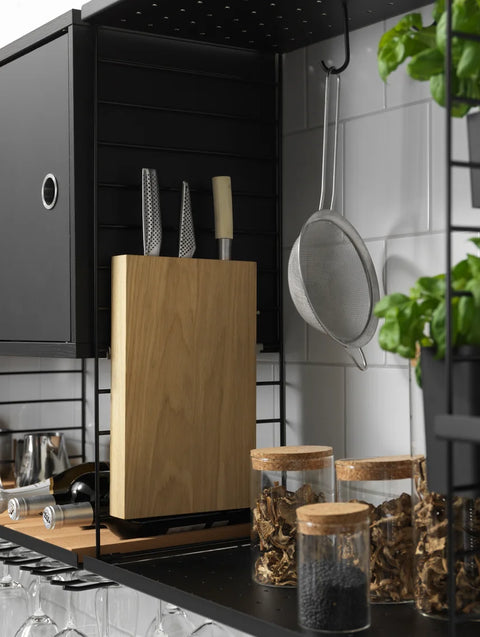 Black Cabinet with Swing Door in String® System kitchen shelving with knives and jars