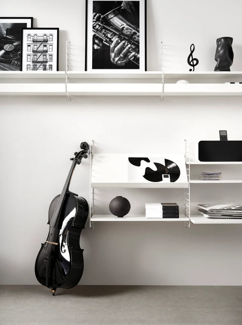 White String™ system with Magazine Shelf, styled with vinyl records and black cello in modern interior