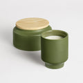 Lost in the Mild Outdoor Candle by Blu Dot in Olive, large and small sizes shown with wood lid