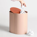 Blu Dot Binwell Wastebasket in Blush with terracotta swing-top lid open showing interior