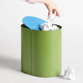 Blu Dot Binwell Wastebasket in Grasshopper green with blue swing-top lid open showing interior