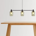 Blu Dot Bub Chandelier in olive hand-blown glass with black metal bar styled above a white oak dining table