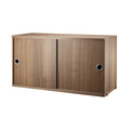 String Furniture cabinet with sliding doors in walnut – Scandinavian modular storage solution