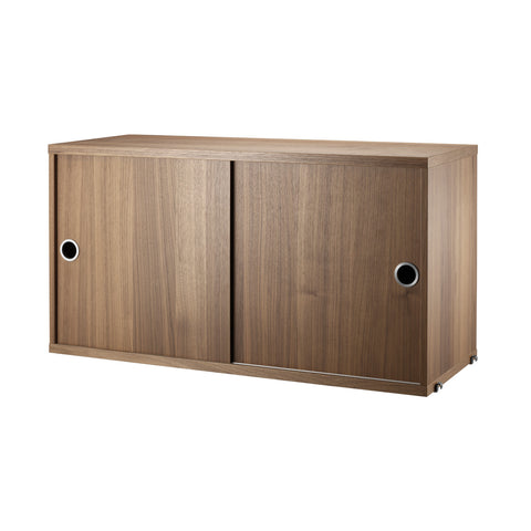 String Furniture cabinet with sliding doors in walnut – Scandinavian modular storage solution
