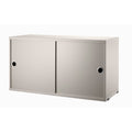 String Furniture cabinet with sliding doors in beige – versatile Scandinavian storage unit