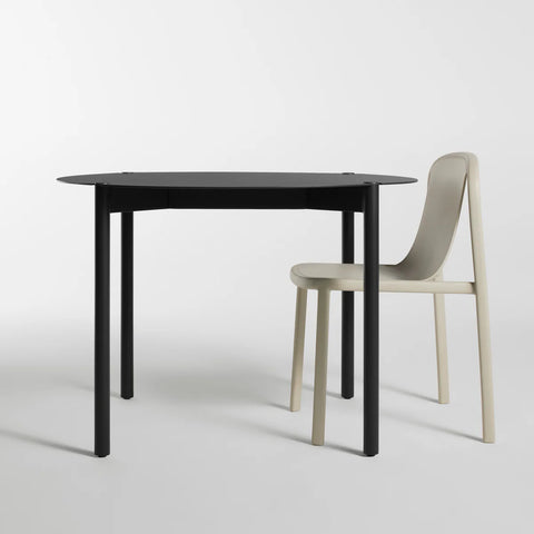 Comeuppance Round Dining Table by Blu Dot in Oblivion, styled with Decade Chair in Putty