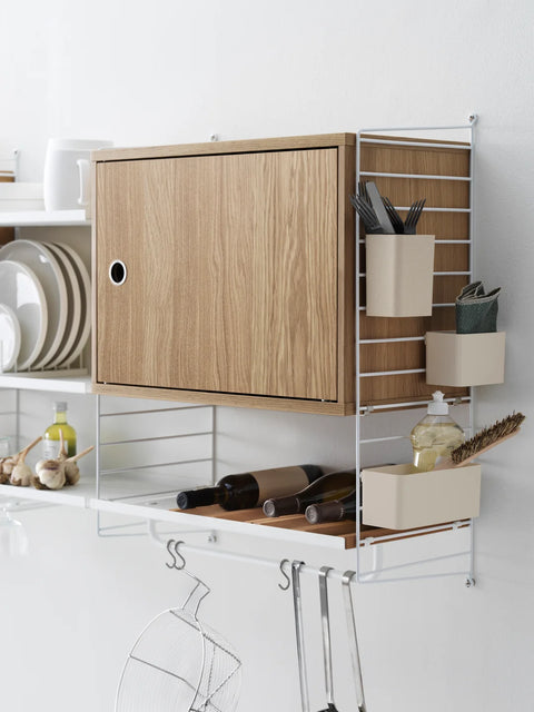 String® System wall panels in white with oak cabinet, kitchen storage accessories, and modular shelving
