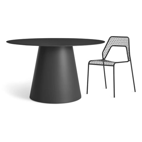 Circula 52" Dining Table by Blu Dot in Oblivion, styled with Hot Mesh Chair in Black