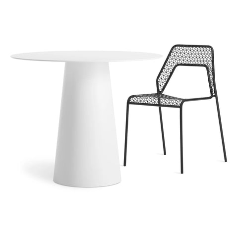 Circula 36" Dining Table by Blu Dot in White, styled with Hot Mesh Chair in Black